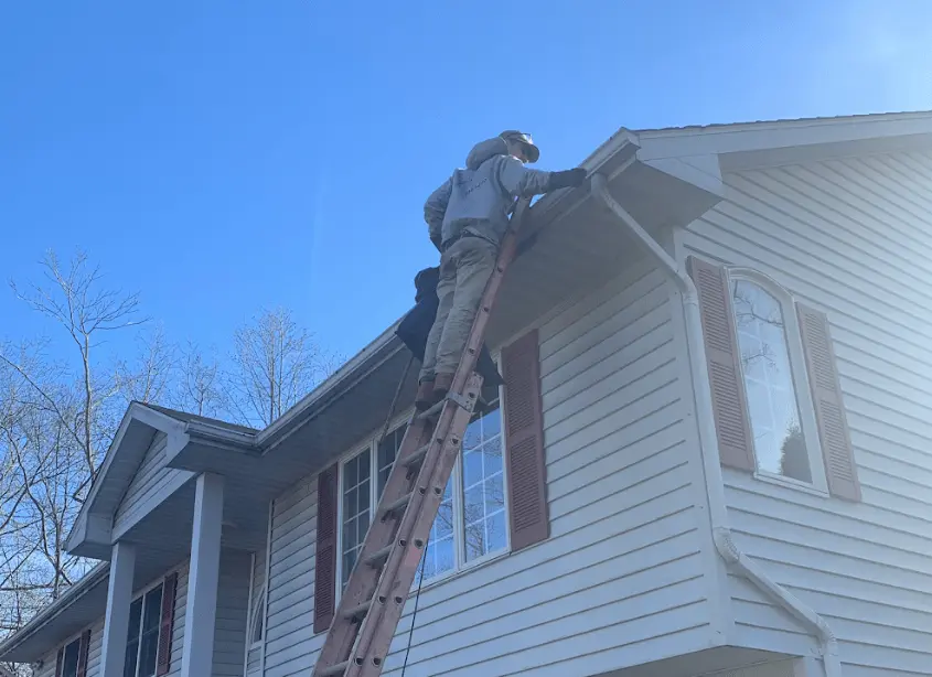 Gutter cleaning and maintenance being performed by Streetsboro Power Washing in Streetsboro
